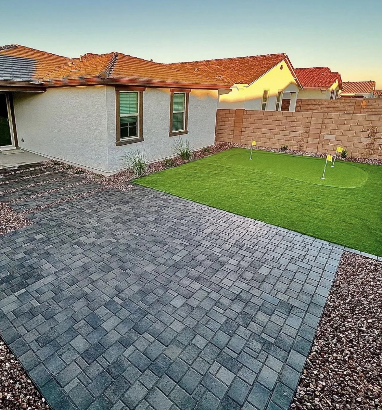 Turf Time AZ project with a gray paver patio beside a turf lawn