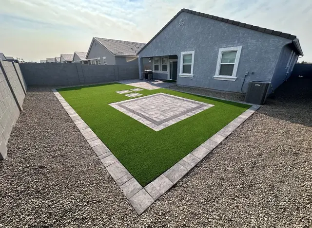 Artificial turf lawn with a square paver pad and paver border