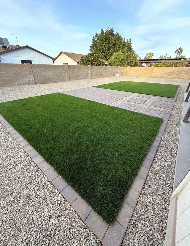 Two artificial turf areas connected by a paver walkway and stepping pads