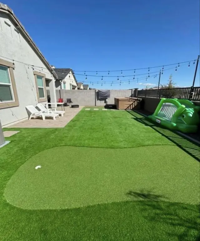 Turf putting green with a larger artificial turf lawn and patio