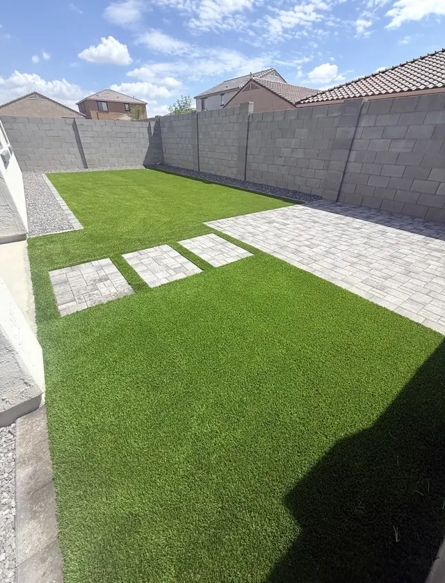 Artificial turf lawn with square paver stepping pads and a patio